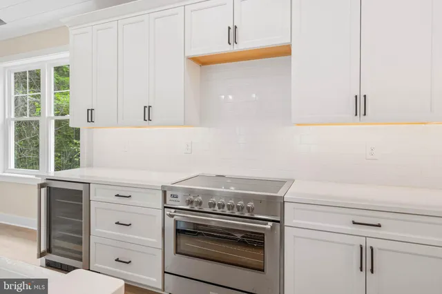 a stove top oven sitting inside of a kitchen