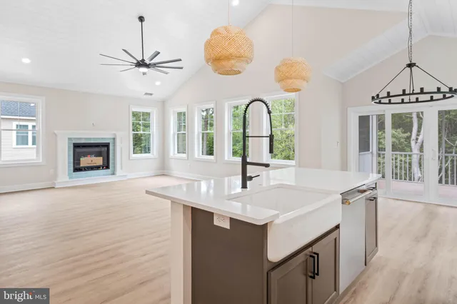 a kitchen with a sink appliances and a chandelier