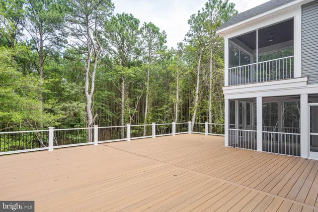 a view of a house with a wooden fence