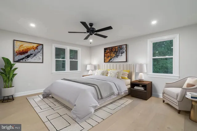 a bedroom with a large bed couch and a window