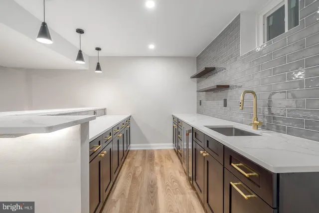 a kitchen with a sink stove and cabinets