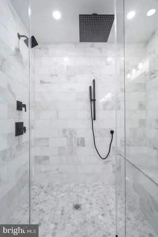 a bathroom with a glass shower door