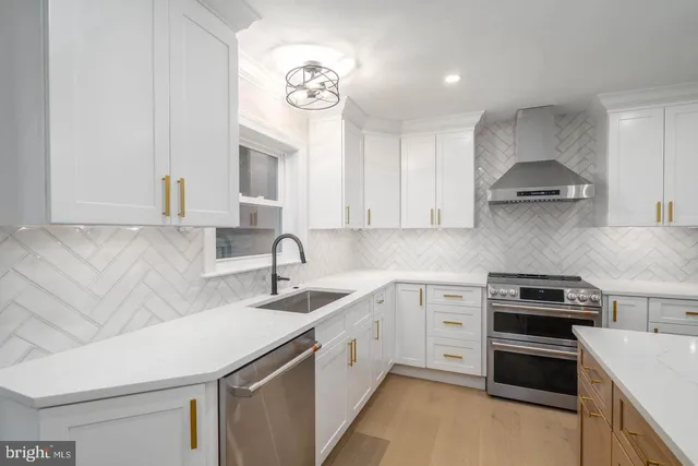 a kitchen that has a sink and a stove