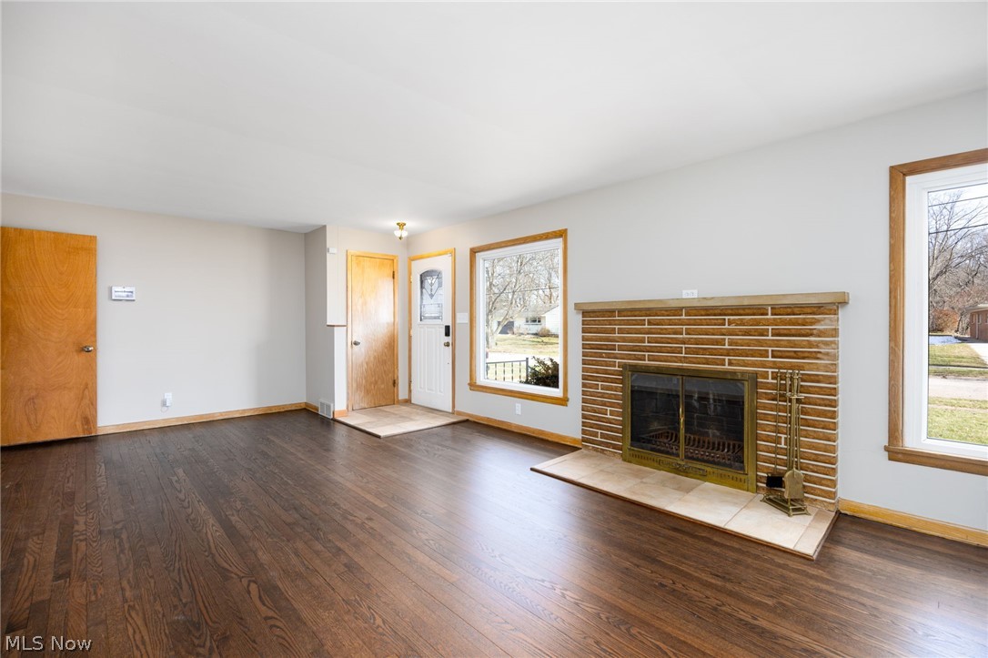 364 Mowbray Road Akron, OH 44333 - Photo 5 of 44 Unfurnished living room with dark wood flooring and a fireplace