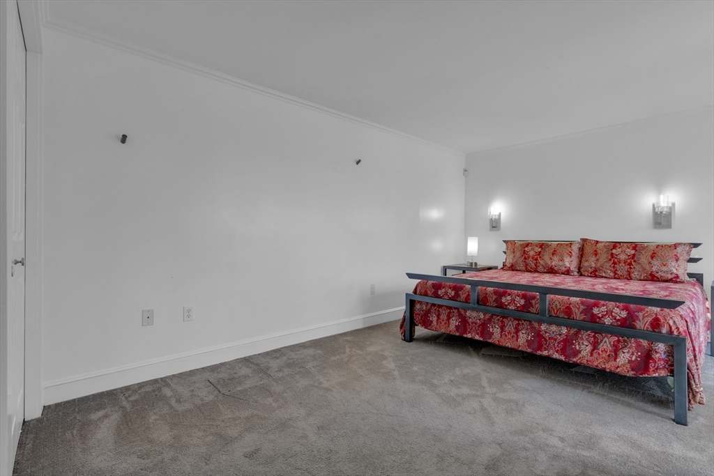 232 Summit Avenue, Unit A1 Brookline, MA 02446 - Photo 13 of 29 a large room with a bed and a couch