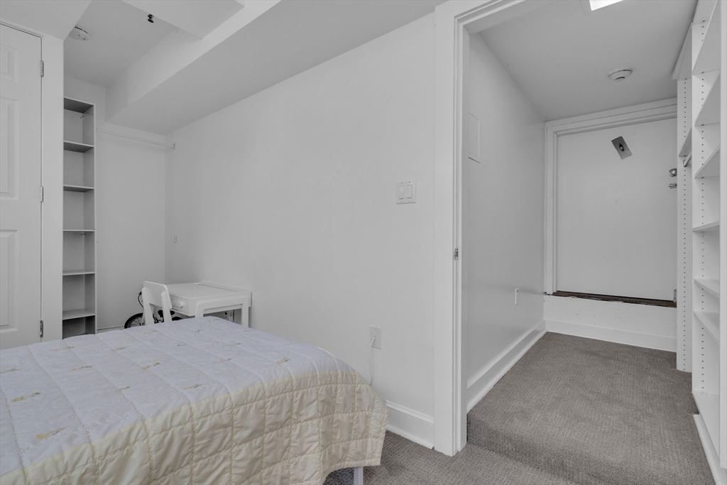 232 Summit Avenue, Unit A1 Brookline, MA 02446 - Photo 16 of 29 a bedroom with a bed and closet