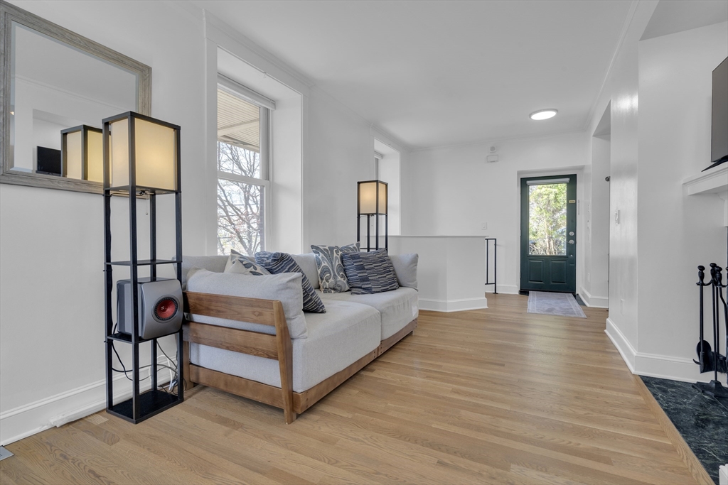 232 Summit Avenue, Unit A1 Brookline, MA 02446 - Photo 4 of 29 a view of a livingroom with furniture wooden floor and windows