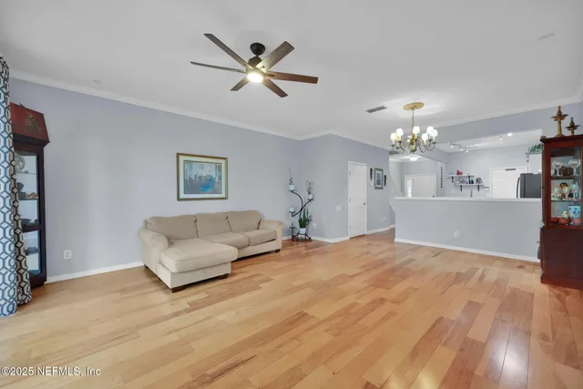 a living room with furniture and a chandelier