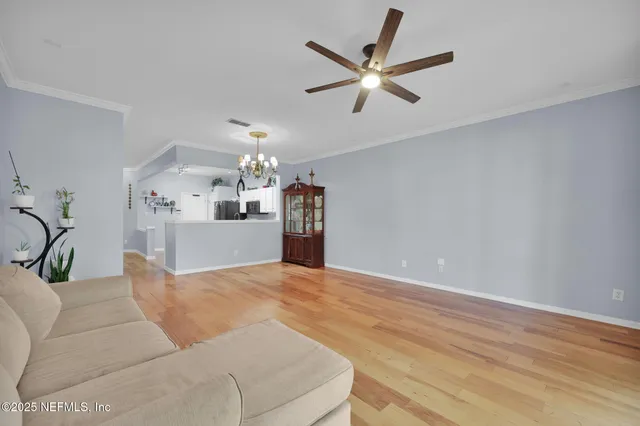 a living room with furniture and kitchen view
