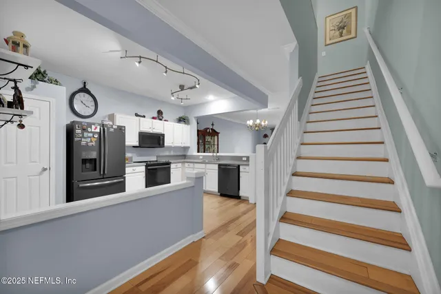 a view of a kitchen with microwave and cabinets
