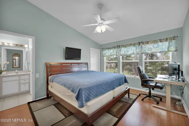a living room with a bed furniture and a large window
