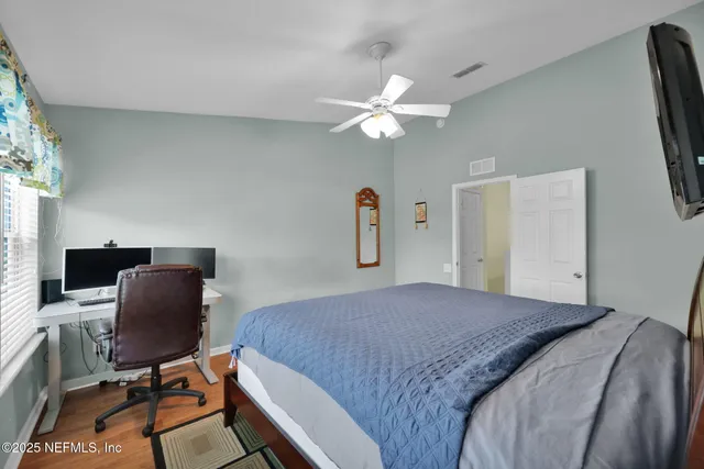 a bedroom with a workspace