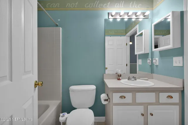 a bathroom with a sink toilet and mirror