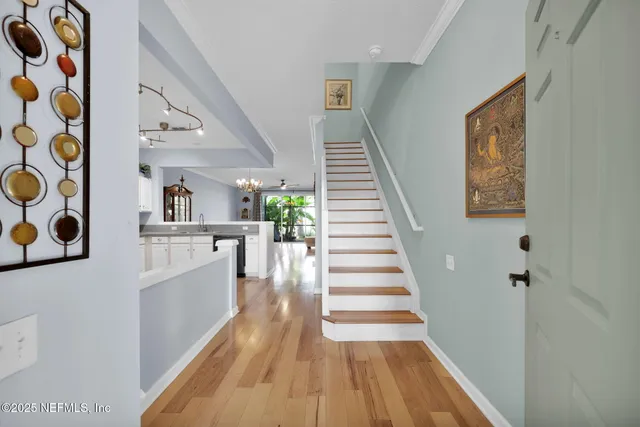 a view of entryway and hall with wooden floor