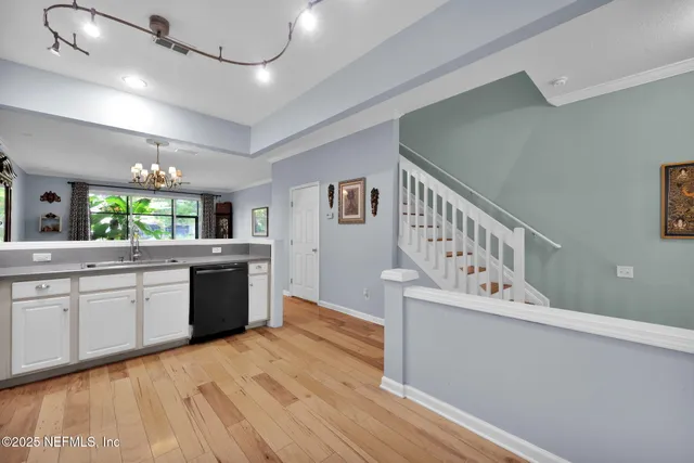 a kitchen with cabinets a sink and appliances
