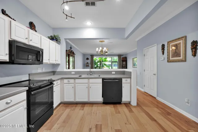 a large kitchen with stainless steel appliances granite countertop a stove and a sink