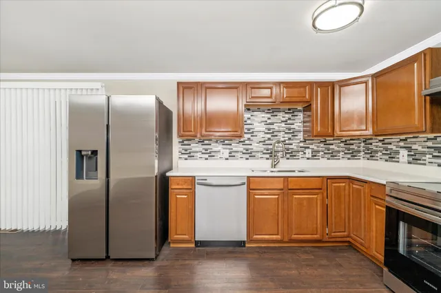 a kitchen with stainless steel appliances granite countertop a refrigerator and a sink