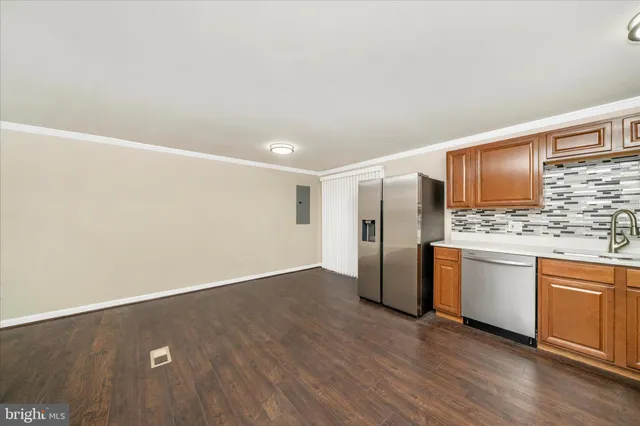 a kitchen with stainless steel appliances granite countertop a refrigerator sink and microwave