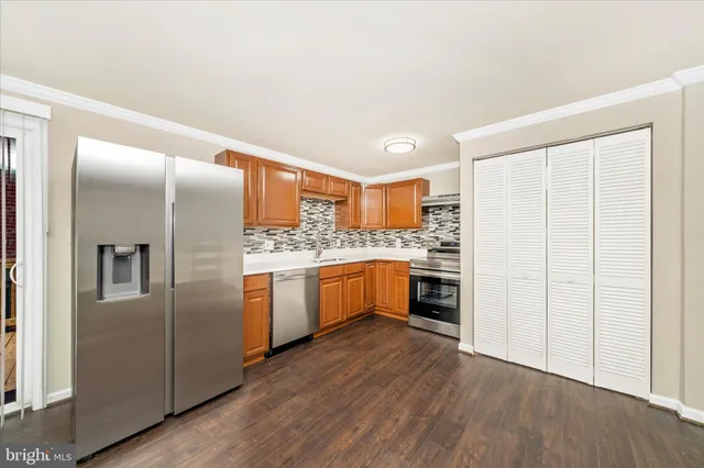 a kitchen with stainless steel appliances a refrigerator sink and cabinets