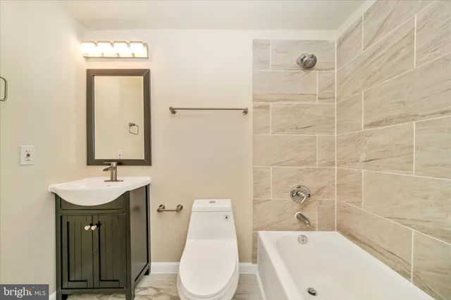 a bathroom with a sink and mirror with toilet