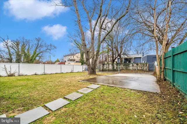 a view of yard with swimming pool and sitting area