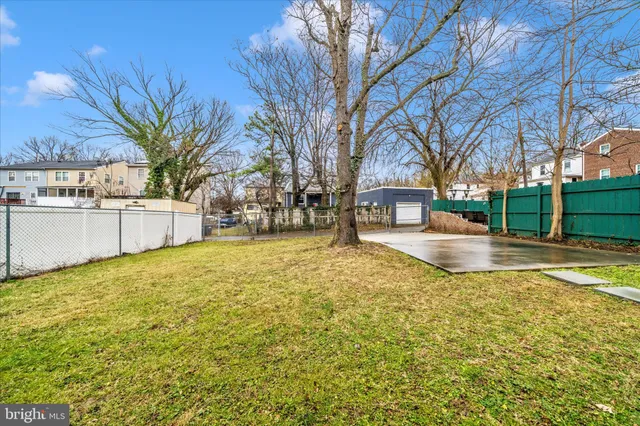 a view of yard with swimming pool and trees