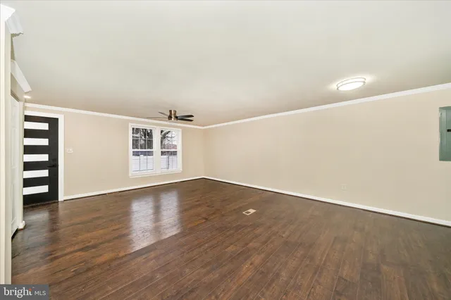 wooden floor in an empty room with a window
