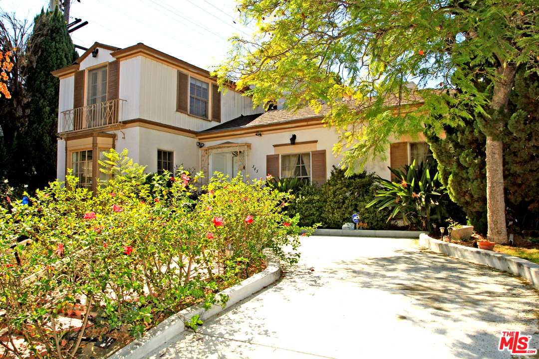 345 South Camden Drive Beverly Hills, CA 90212 - Photo 1 of 13 a front view of a house with a yard