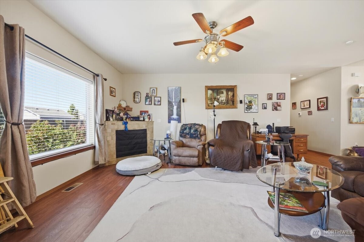 2304 Road 52 Pasco, WA 99301 - Photo 11 of 39 a living room with furniture a fireplace and a large window