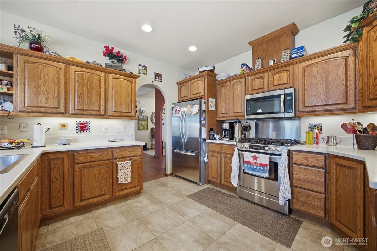 2304 Road 52 Pasco, WA 99301 - Photo 14 of 39 a kitchen with stainless steel appliances granite countertop a sink dishwasher stove top oven and refrigerator