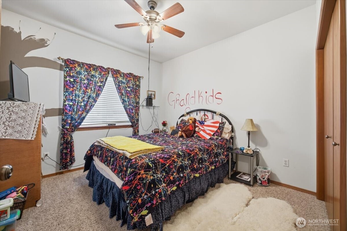 2304 Road 52 Pasco, WA 99301 - Photo 23 of 39 a bedroom with bed and a chandelier