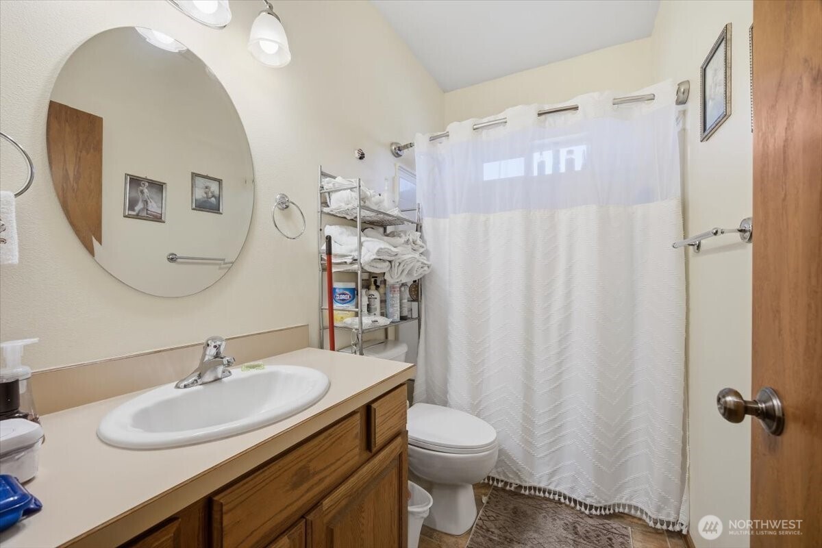 2304 Road 52 Pasco, WA 99301 - Photo 24 of 39 a bathroom with a sink vanity mirror and toilet