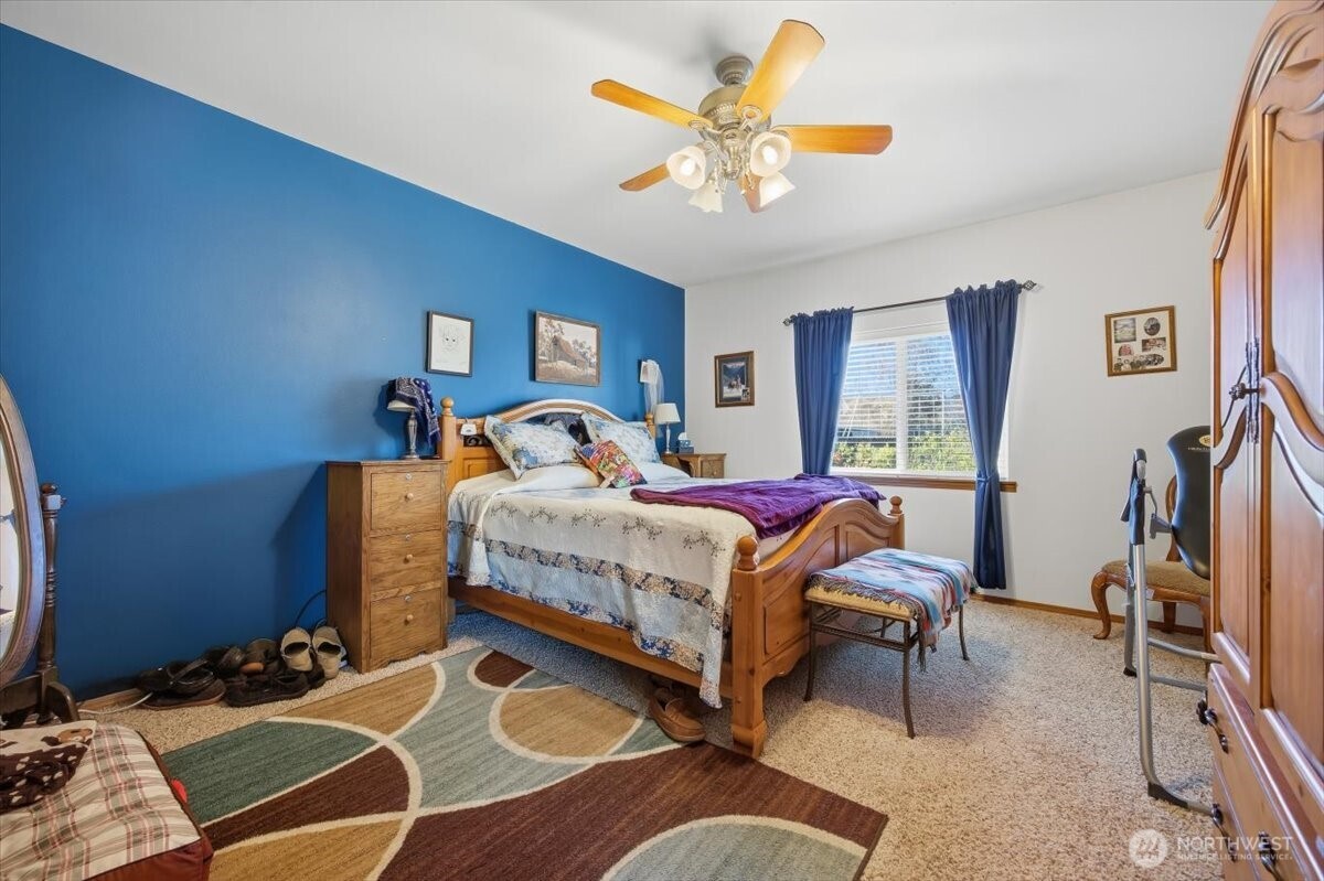 2304 Road 52 Pasco, WA 99301 - Photo 25 of 39 a bedroom with a bed a chandelier and dresser