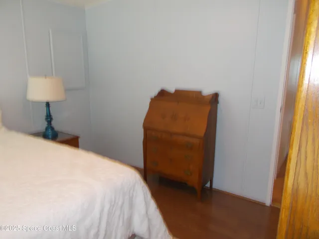 a bedroom with a bed and a chair