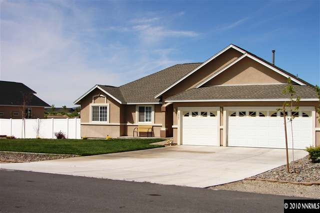 1885 Heidi Road Fallon, NV 89406 - Photo 1 of 9 a front view of a house with a yard and garage