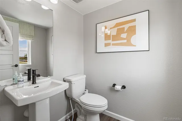 a bathroom with a shower sink and mirror