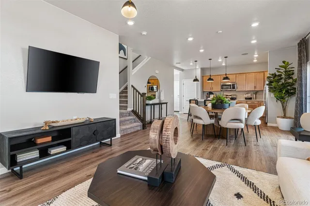 a view of a dining room with furniture wooden floor and a kitchen