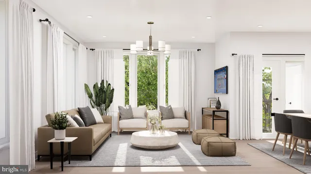 a living room with furniture potted plant and a large window