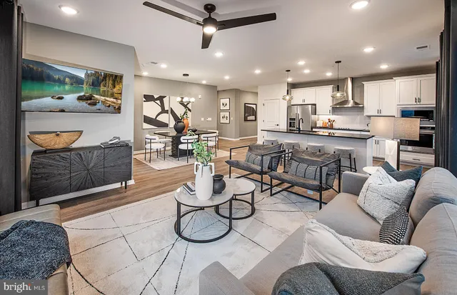 a living room with furniture and kitchen view