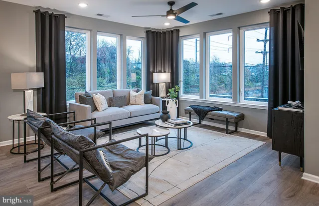 a living room with furniture and a floor to ceiling window