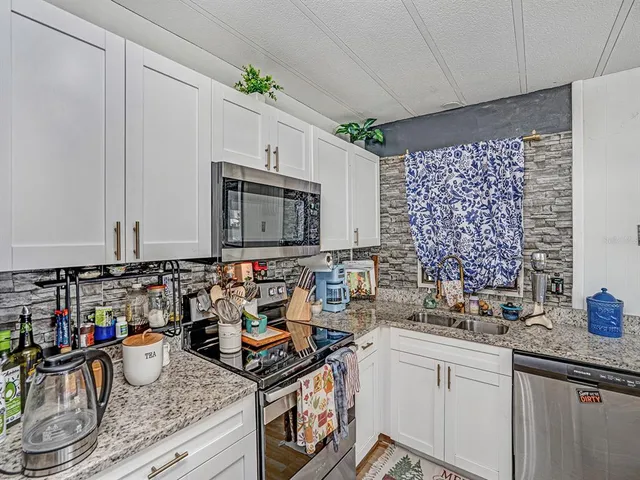 a kitchen with sink cabinets and microwave