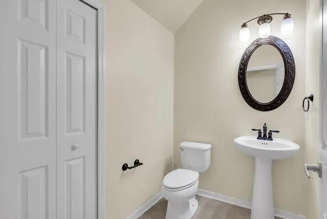 a kitchen with stainless steel appliances granite countertop a refrigerator a sink dishwasher a stove and a refrigerator with wooden floor