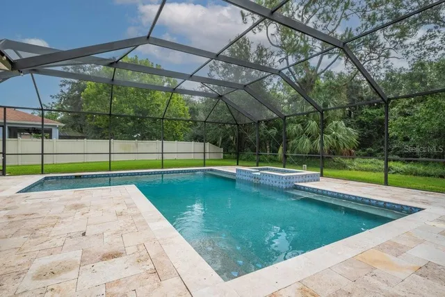 a view of a backyard with swimming pool