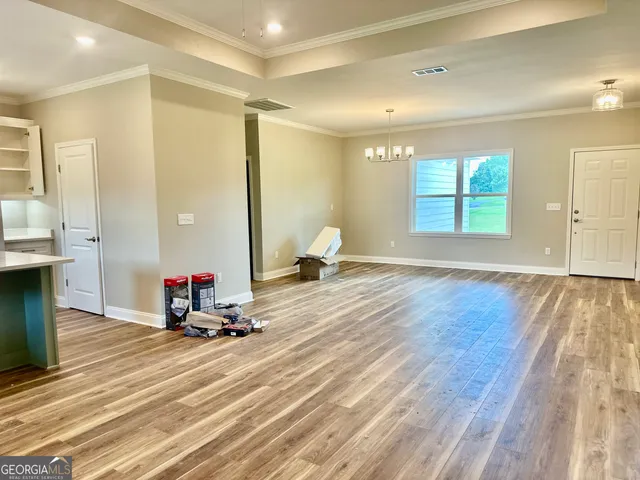 a view of a room with wooden floor and windows