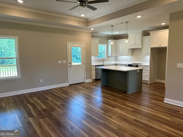 a view of kitchen with sink and wooden floor