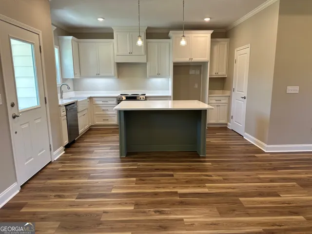 a large kitchen with stainless steel appliances granite countertop a stove and a refrigerator