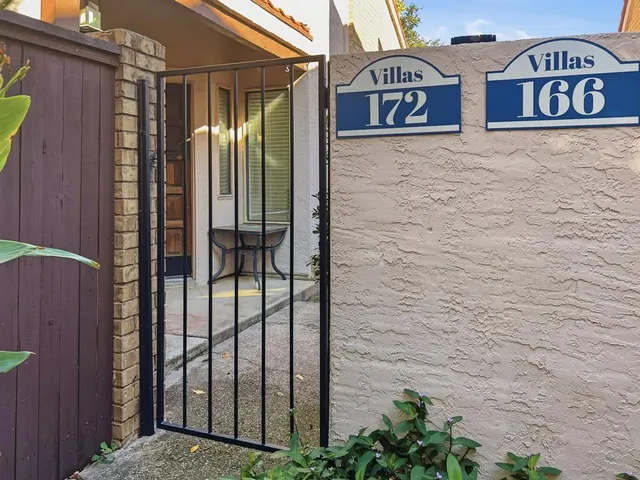 a view of a wooden door with a sign on the wall