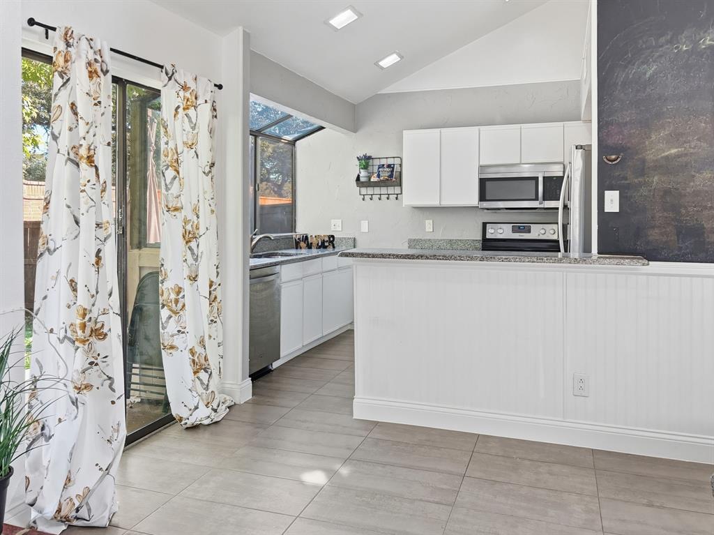 539 Ranch Trail, Unit 172 Irving, TX 75063 - Photo 13 of 40 a kitchen with stainless steel appliances a refrigerator and a stove top oven