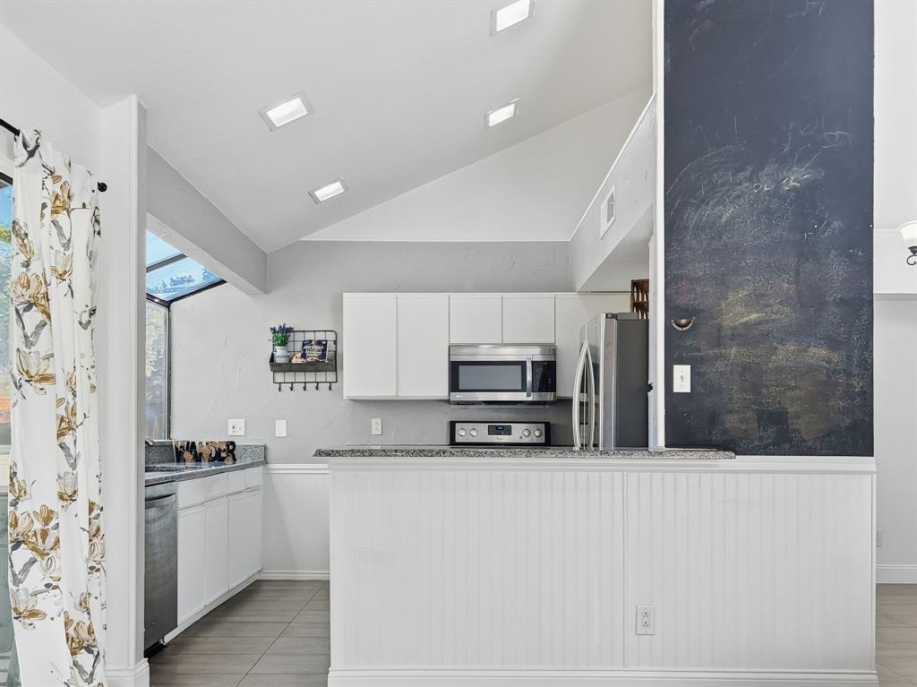 539 Ranch Trail, Unit 172 Irving, TX 75063 - Photo 15 of 40 a kitchen with a refrigerator and a stove top oven