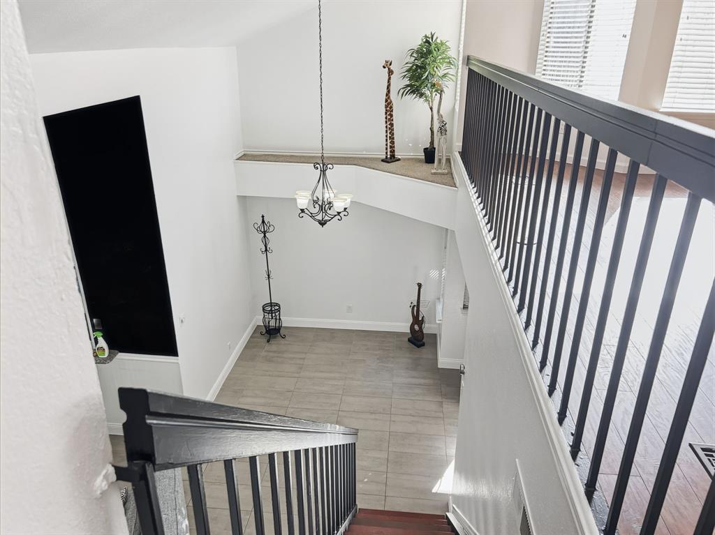 539 Ranch Trail, Unit 172 Irving, TX 75063 - Photo 16 of 40 a view of a hallway with wooden floor and staircase
